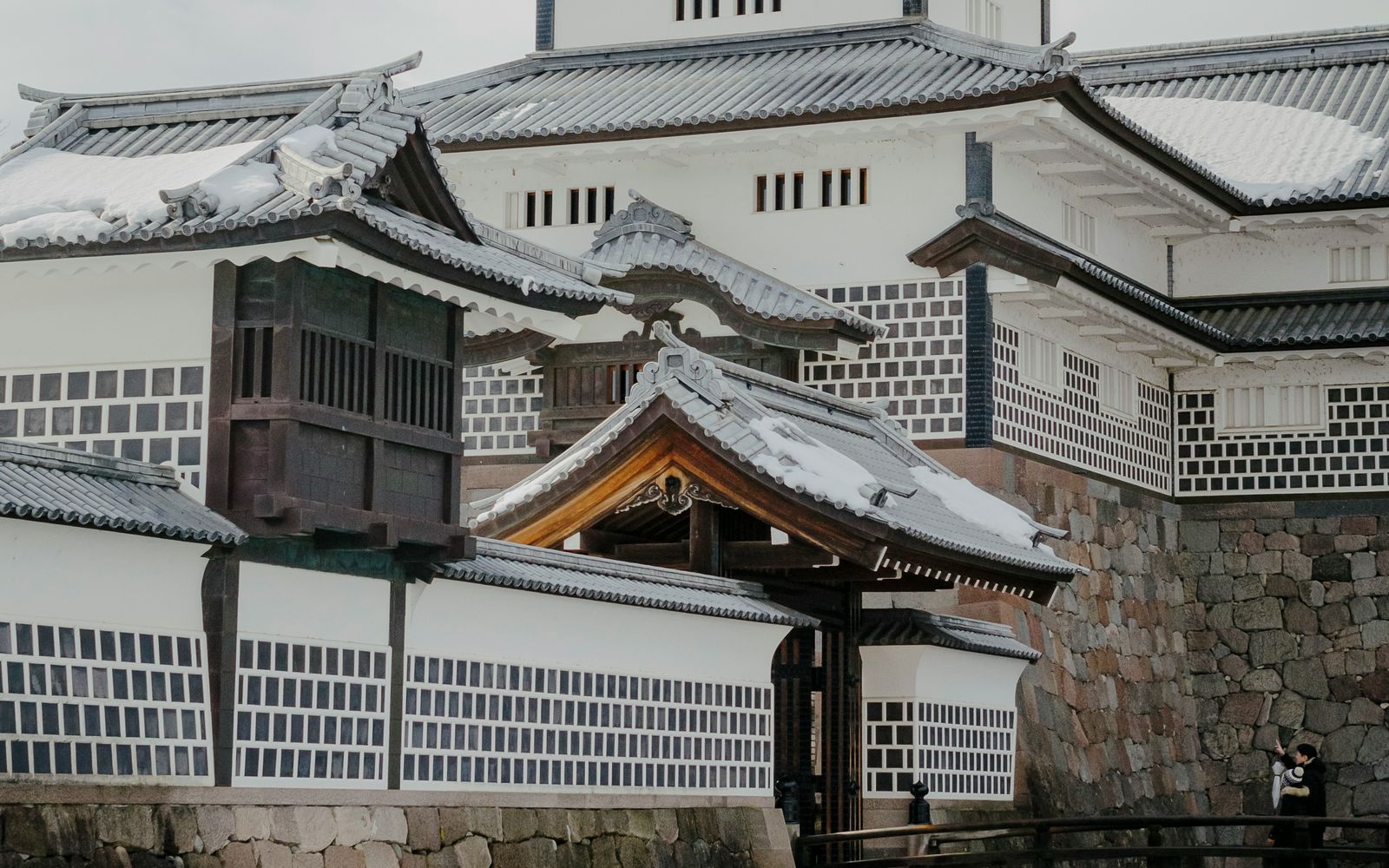 Kanazawa Castle under snow above its stone walls and moat